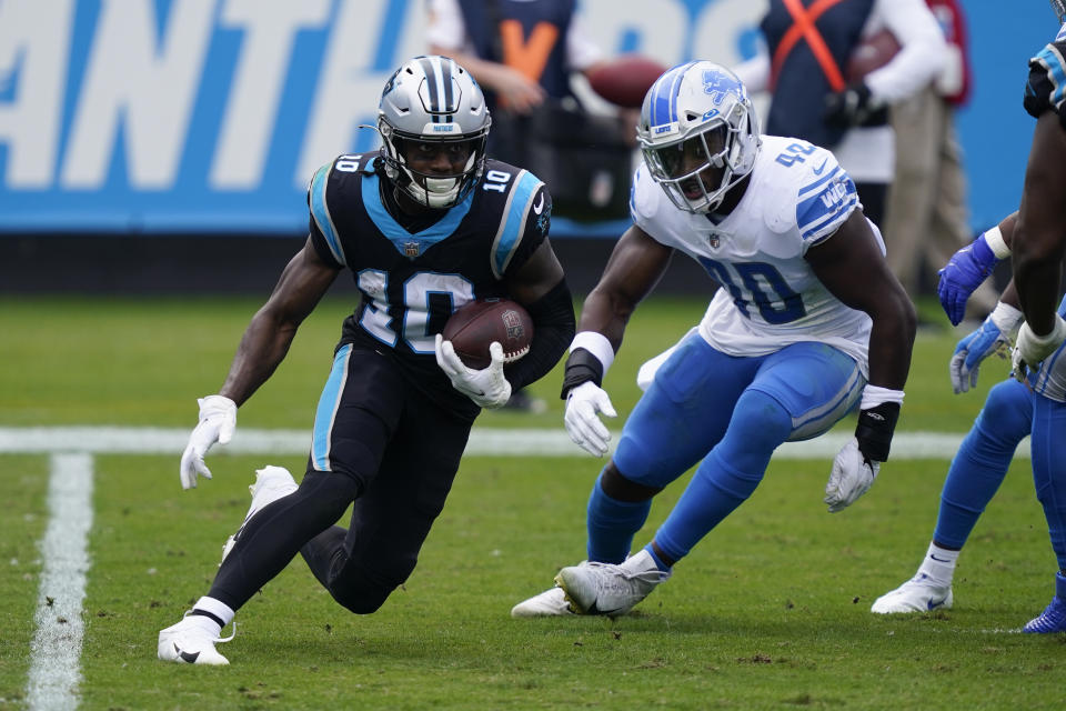 Carolina Panthers wide receiver Curtis Samuel, left, runs past Detroit Lions middle linebacker Jarrad Davis during the first half of an NFL football game Sunday, Nov. 22, 2020, in Charlotte, N.C. (AP Photo/Gerry Broome)
