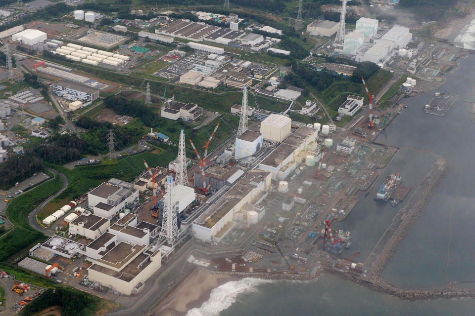 FILE - This aerial file photo taken in Aug. 2013, shows No 4, 3, 2, 1, 5 and 6 reactors, from bottom to top, at the Fukushima Dai-ichi nuclear power plant in Futaba town, Fukushima Prefecture, northeastern Japan. Eyeing dozens of aging reactors at home and hundreds of others worldwide that eventually need to be retired, Japanese industry sees a profitable market for decommissioning expertise. (AP Photo/Kyodo News, File) JAPAN OUT, MANDATORY CREDIT