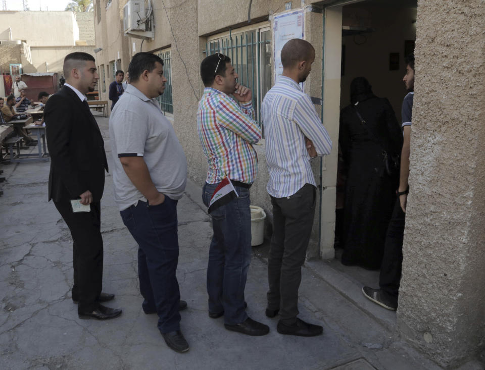 Iraqi citizens queue to vote at a polling center in Baghdad, Iraq, Wednesday, April 30, 2014. A key election for a new Iraqi parliament was underway on Wednesday amid a massive security operation as the country continued to slide deeper into sectarian violence more than two years after U.S. forces left the country. (AP Photo/Khalid Mohammed)