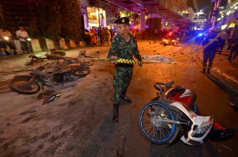 A soldier cordons off the scene after a bomb exploded outside a religious shrine in central Bangkok on August 17, 2015