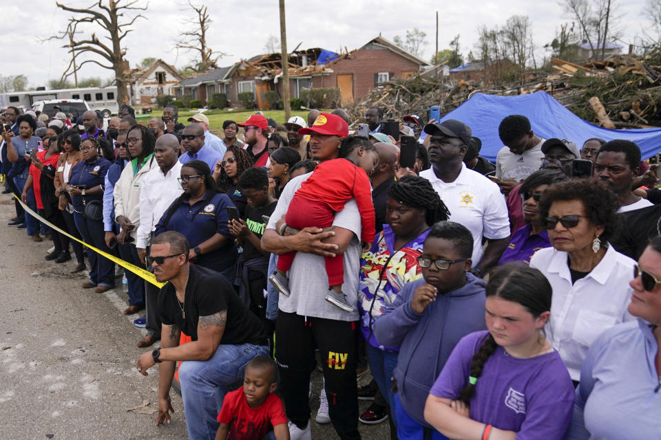 People listen as President Joe Biden speaks in Rolling Fork, Miss., Friday, March 31, 2023. Biden traveled to Rolling Fork to survey the damage after a deadly tornado and severe storm moved through the area. (AP Photo/Carolyn Kaster)