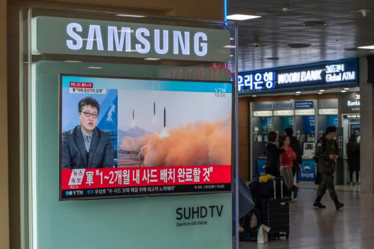 A TV screen shows news coverage of a North Korean rocket launch, during a broadcast to commuters at Seoul station on March 7, 2017