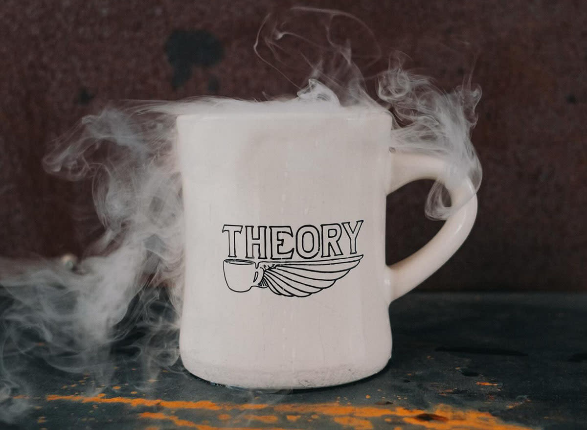 A steamy white mug of coffee emblazoned with the logo of San Antonio's Theory Coffee