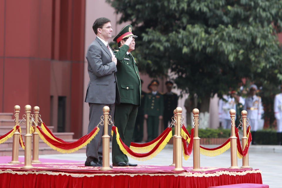 U.S. Defense Secretary Mark Esper and Vietnamese Defense Minister Ngo Xuan Lich stand for national anthems during a welcome ceremony in Hanoi, Vietnam Wednesday, Nov. 20, 2019. Esper is on a visit to Vietnam to strengthen the military relations with the Southeast Asian nation. (AP Photo/Hau Dinh)