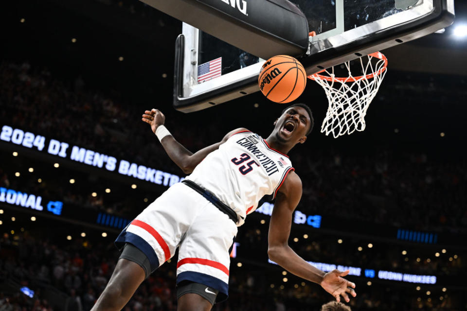  Samson Johnson of the Connecticut Huskies celebrates after a dunk against Illinois Fighting Illini during the first half in the Elite Eight round of the 2024 NCAA Men's Basketball Tournament. 