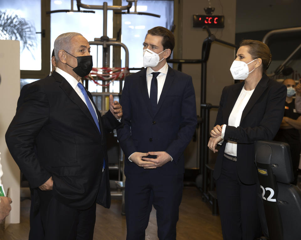 Israeli Prime Minister Benjamin Netanyahu, left, visits a fitness gym with Austrian Chancellor Sebastian Kurz, center, and Danish Prime Minister Mette Frederiksen, to observe how the "Green Pass," for citizens vaccinated against COVID-19, is used, in Modi'in, Israel, Thursday, March 4, 2021. Frederiksen and Kurz are on a short visit to Israel for to pursue the possibilities for closer cooperation on COVID-19 and vaccines. (Avigail Uzi/Pool via AP)