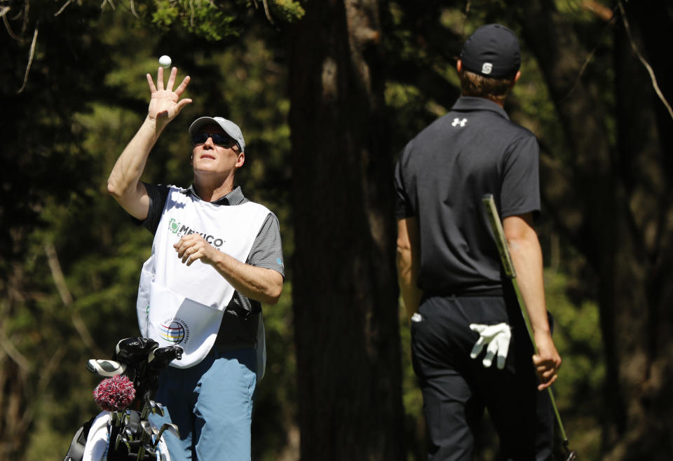 Shawn Spieth catches a ball thrown by his son Jordan Spieth during the first day of competition of the WGC-Mexico Championship at the Chapultepec Golf Club in Mexico City, Thursday, Feb. 21, 2019. Spieth’s father caddied nine holes of practice Wednesday and will be on the bag the rest of the week after Spieth's caddie left because of the death of his father. (AP Photo/Marco Ugarte)