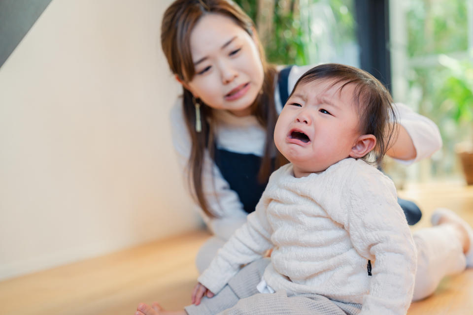 Babysitter nursing a crying baby