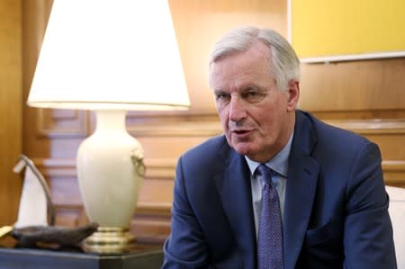 FILE PHOTO: EU chief Brexit negotiator Michel Barnier speaks with Greek Prime Minister Alexis Tsipras at the Maximos Mansion in Athens