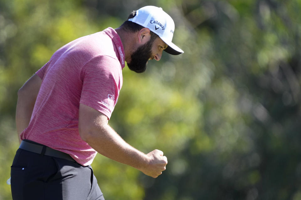 Jon Rahm, of Spain, celebrates his birdie putt on the 18th green during the final round of the Tournament of Champions golf event, Sunday, Jan. 8, 2023, at Kapalua Plantation Course in Kapalua, Hawaii. (AP Photo/Matt York)