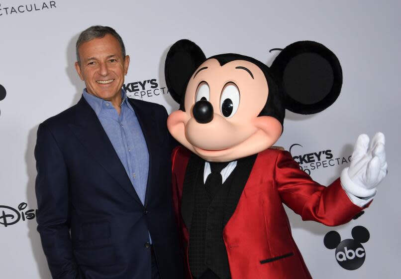 Walt Disney Company Chairman and CEO Robert A Iger poses with Mickey Mouse attends Mickey's 90th Spectacular at The Shrine Auditorium on October 6, 2018 in Los Angeles. (Photo by VALERIE MACON / AFP) (Photo credit should read VALERIE MACON/AFP via Getty Images)