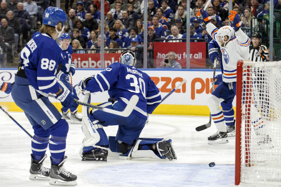 Edmonton Oilers center Leon Draisaitl (29) celebrates a goal against Toronto Maple Leafs goaltender Matt Murray (30) during the first period of an NHL hockey game in Toronto, Saturday, March 11, 2023. (Cole Burston/The Canadian Press via AP)