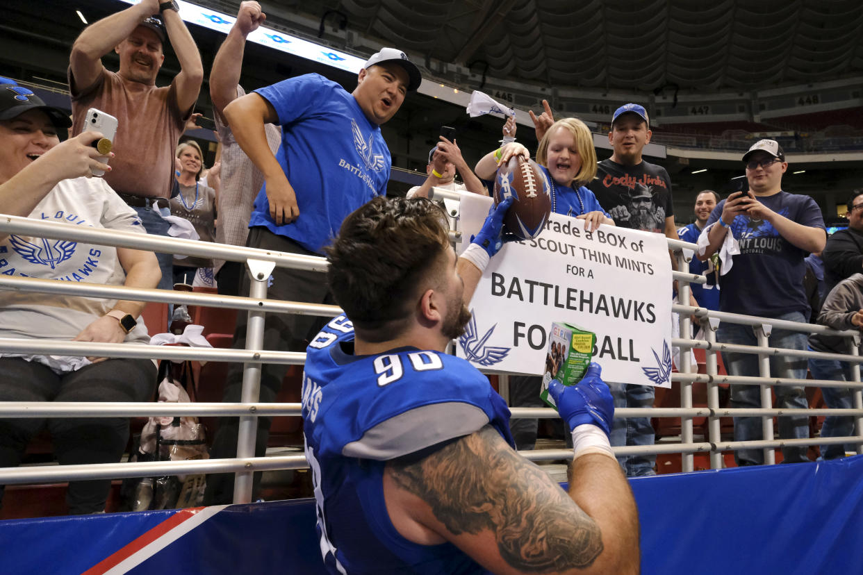 ST. LOUIS, MO - FEBRUARY 23: Casey Sayles #90 of the St. Louis BattleHawks fulfilled a wish from a young fan holding a sign saying she would trade a box of Girl Scout Thin Mints for a Battlehawks football. The exchange happened during the XFL game against the New York Guardians at The Dome at America's Center on February 23, 2020 in St. Louis, Missouri. (Photo by Scott Rovak/XFL via Getty Images)