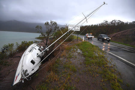 A yacht lies beside a road after Cyclone Debbie hit the northern Queensland town of Airlie Beach, located south of Townsville in Australia, March 29, 2017. AAP/Dan Peled/via REUTERS