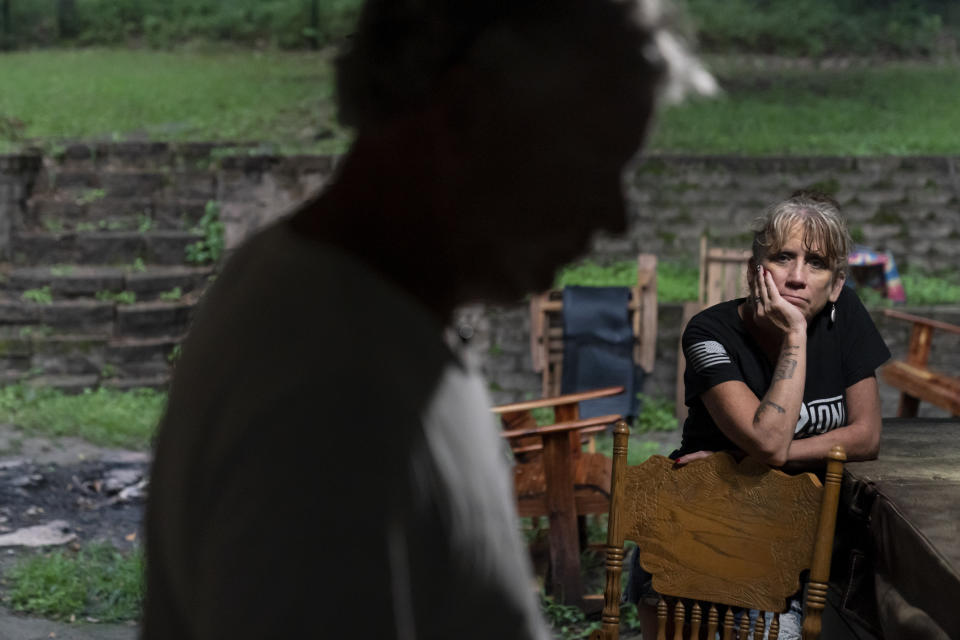 Barbie Rohde, right, looks toward her husband, Robert, after they returned home from a festival where they volunteered for Mission 22, a nonprofit that is focused on ending military and veteran suicide, Saturday, June 10, 2023, in Flint, Texas. Robert thinks that for his wife, deep down, it’s not really about raising money _ that’s just the easiest way to track how much people care, so when she goes to visit Cody soon at the national cemetery, she can whisper to him that his death was not for nothing. (AP Photo/David Goldman)