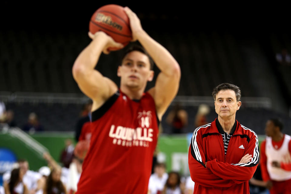 NEW ORLEANS, LA - MARCH 30: (R) Head coach Rick Pitino of the Louisville Cardinals watches as Kyle Kuric #14 shoots the ball during practice prior to the 2012 Final Four of the NCAA Division I Men's Basketball Tournament at the Mercedes-Benz Superdome on March 30, 2012 in New Orleans, Louisiana. (Photo by Jeff Gross/Getty Images)