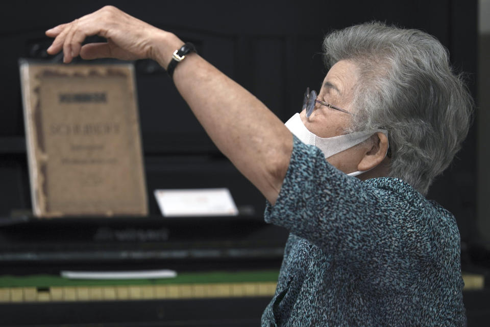 Kisako Motoki, who lost her parents and siblings to the Great Tokyo Air Raid on March 10, 1945, speaks during an interview with the Associated Press at the Center for the Tokyo Raids and War Damage in Tokyo Wednesday, July 29, 2020. In Japan, war orphans were punished for surviving. They were bullied. They were called trash, sometimes rounded up by police and put in cages. Some were sent to institutions or sold for labor. They were targets of abuse and discrimination. Now, 75 years after the war's end, some are revealing their untold stories of recovery and pain, underscoring Japan’s failure to help its own people. (AP Photo/Eugene Hoshiko)