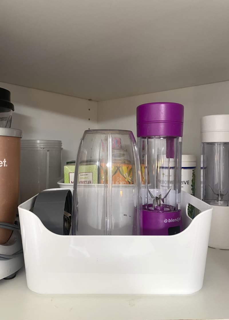 Pantry organizer holding blender items.