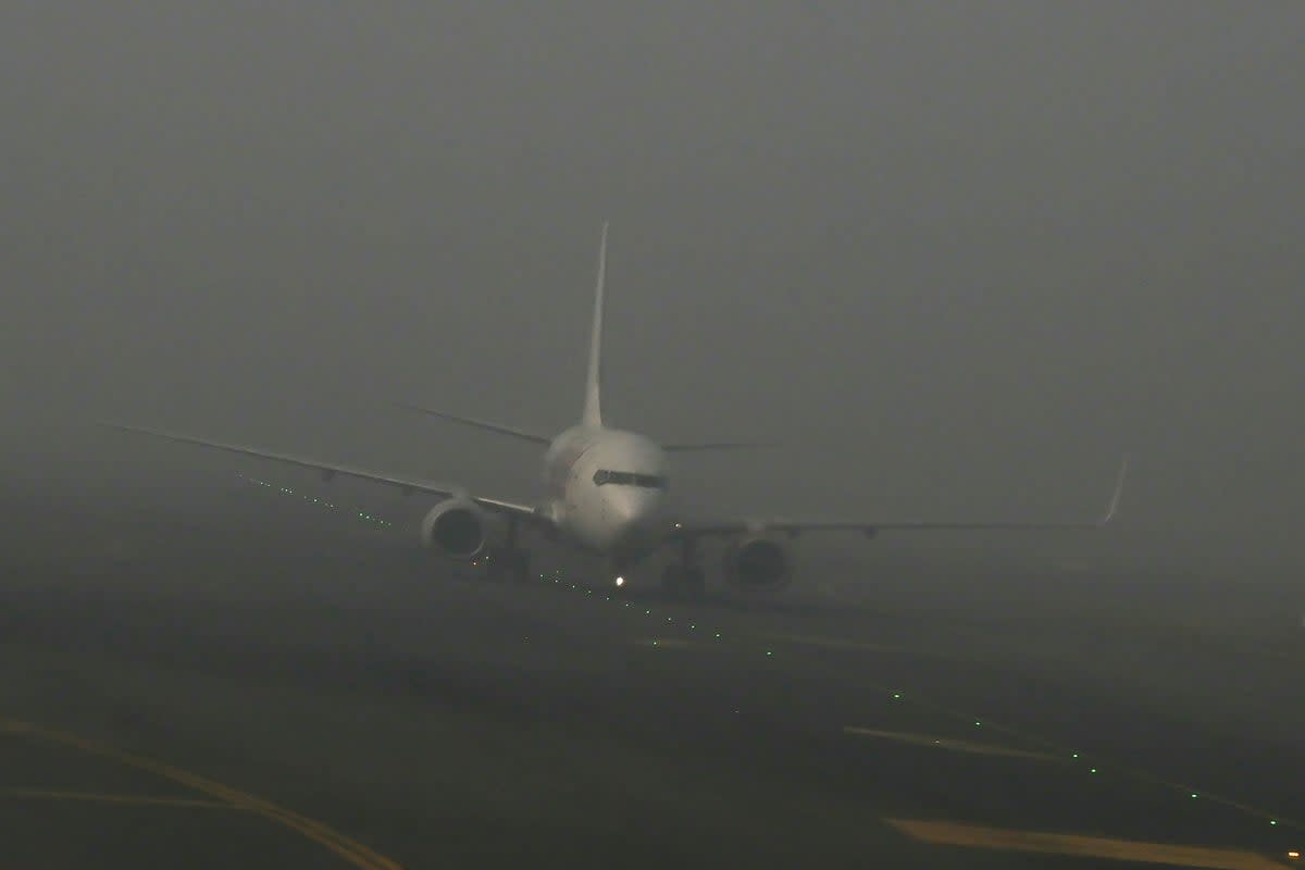 An aircraft prepares to take off amid dense fog on a cold winter morning at Indira Gandhi International Airport in New Delhi (AFP via Getty Images)