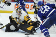 Pittsburgh Penguins goaltender Tristan Jarry (35) stops Toronto Maple Leafs forward Michael Bunting (58) during the second period of an NHL hockey game Thursday, Feb. 17, 2022, in Toronto. (Nathan Denette/The Canadian Press via AP)