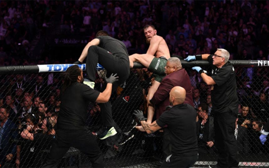 Scenes of utter mayhem here in Sin City as the biggest mixed martial arts event in history ended in a mass brawl between the teams of the two headline contenders, combat sports star Conor McGregor, of Ireland, and Dagestan's Khabib Nurmagomedov, who retained his Ultimate Fighting Championship lightweight crown by submitting his rival in the fourth round.