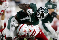 Michigan State's Jayden Reed, top, is stopped by Nebraska's Deontai Williams (8) during the first quarter of an NCAA college football game, Saturday, Sept. 25, 2021, in East Lansing, Mich. (AP Photo/Al Goldis)