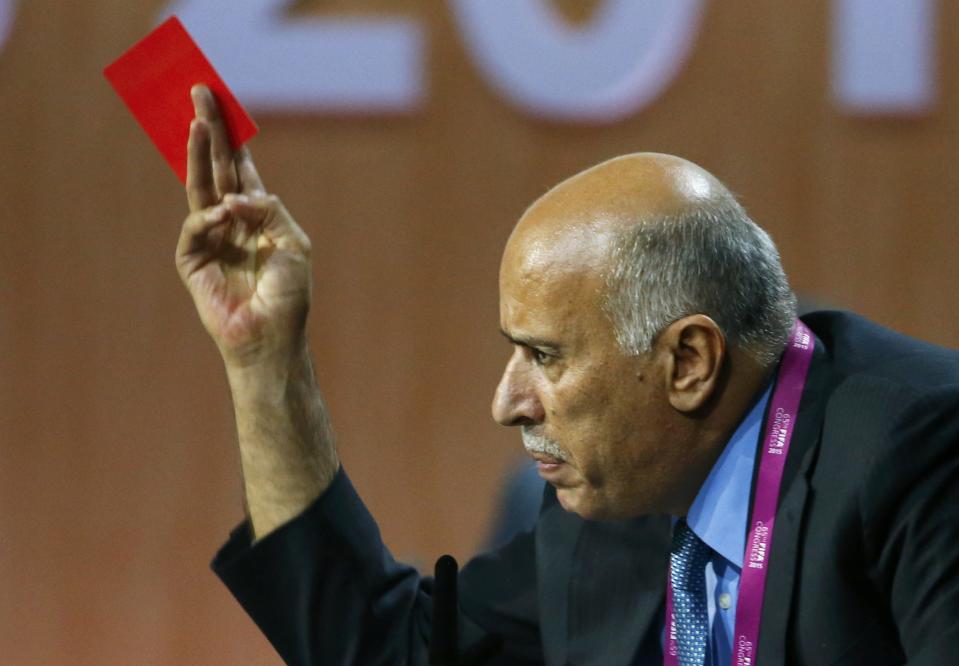 Al Rajoub, President of Palestinian Football Association, gestures with a red card as he addresses the 65th FIFA Congress in Zurich