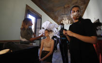 A model gets her make-up done in the backstage at the "We are Made in Italy - Black Lives Matter in Italian fashion Collection" event during the Milan's fashion week in Milan, Italy, Thursday, Sept. 17, 2020. (AP Photo/Antonio Calanni)