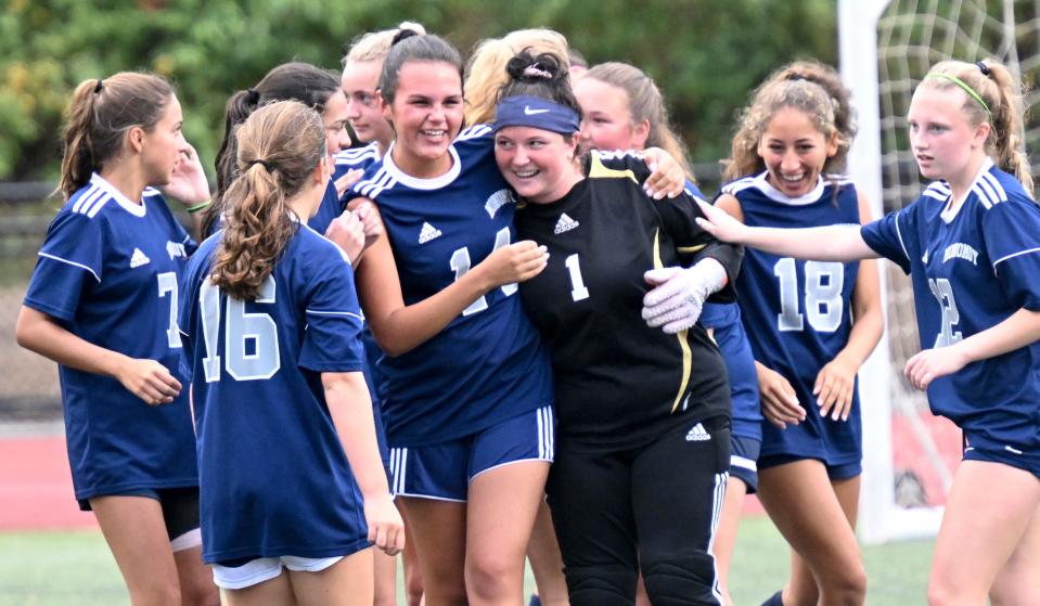 HARWICH   9/13/22    Monomoy  goalie Maya Flaherty is celebrated by her Monomoy soccer team after defeating Nantucket 2-1