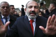 Acting Armenian Prime Minister Nikol Pashinian gestures as he leaves a polling station during an early parliamentary election in Yerevan, Armenia, Sunday, Dec. 9, 2018. The charismatic 43-year-old Nikol Pashinian took office in May after spearheading massive protests against his predecessor's power grab that forced the politician to step down. (Vahan Stepanyan, PAN Photo via AP)