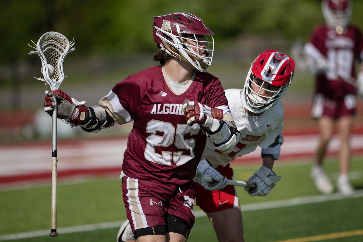 Algonquin's Jack Gulachenski looks to pass ahead of St. John's Connor McKenna.