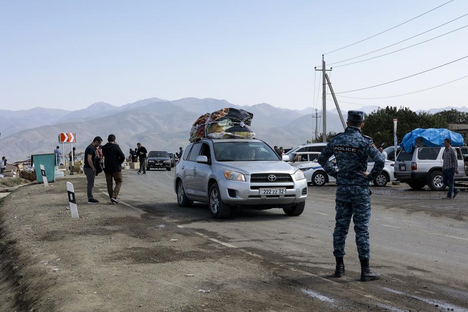 Ethnic Armenians from Nagorno-Karabakh drive their cars to Armenia's Kornidzor in Syunik region, Armenia, Friday, Sept. 29, 2023. Armenian officials say more than 70% of Nagorno-Karabakh's original population have fled the region for Armenia. (AP Photo/Vasily Krestyaninov)