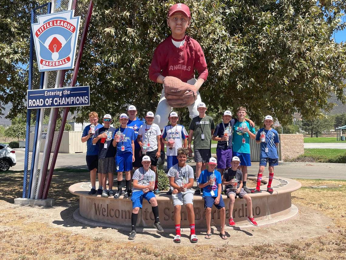 The Bonney Lake-Sumner Little League all stars pose in front of a baseball player statue in San Bernadino, CA. The team won the Northwest regional tournament to become the first team made up exclusively of Pierce County residents to play in the Little League World Series.