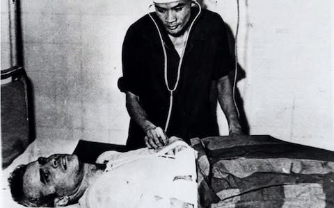 John McCain receiving treatment in captivity in 1967 - Credit: AP