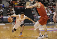 FILE - Japan's Yuki Togashi, left, competes against China's Zhang Zenlin during their FIBA Basketball World Cup 2023 Asian Qualifiers Group B match, Saturday, Nov. 27, 2021, in Sendai, northeastern Japan. The East Asia Super League is set to launch next October featuring some of the region’s biggest domestic clubs. It’s banking on Asia’s home-grown talent to grow from an invitational event to the world’s third-biggest basketball league. One is the so-called Golden Boy of the Philippines. Another is the first 100 million-yen-a-season basketball player in Japan Togashi.(AP Photo/Eugene Hoshiko, File)