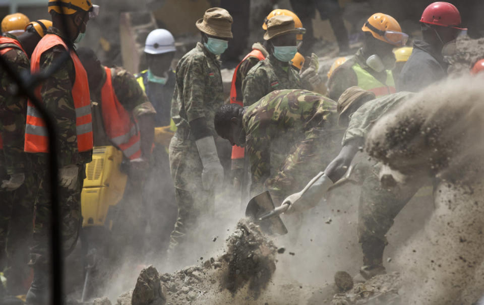 <p>Rescuers use their hands, mechanical tools and a digger to try to free a woman who was trapped for six days in the rubble of a collapsed building, Nairobi, Kenya, Thursday, May 5, 2016.<i> (Photo: Ben Curtis/AP)</i></p><p><br></p>