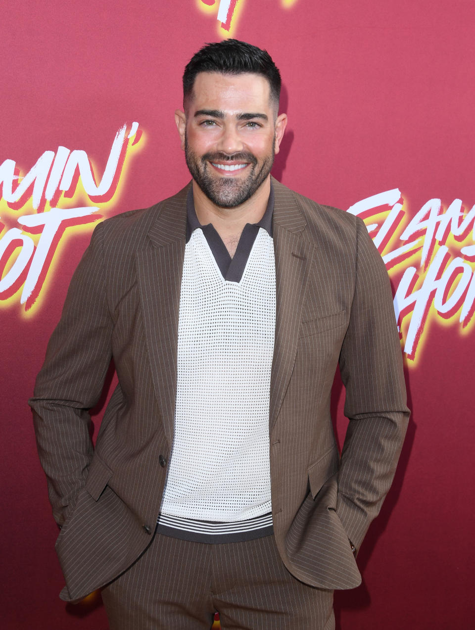 gelled hair and light beard wearing a suit