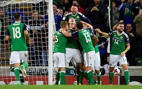 Jonny Evans is mobbed by the team after scoring against the Czech Republic - Credit: Reuters