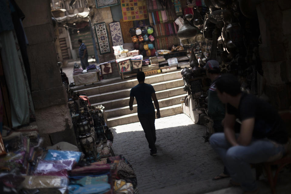 An Egyptian man walks through an empty alley in the Khan El-Khalili market, normally a popular tourist destination, in Cairo, Egypt, Wednesday, Aug. 21, 2013. Riots and killings that erupted across the country after the crackdown against followers of ousted President Mohammed Morsi have delivered a severe blow to Egypt's tourism industry, which until recently accounted for more than 11 percent of the country's gross domestic product and nearly 20 percent of its foreign currency revenues. (AP Photo/Manu Brabo)