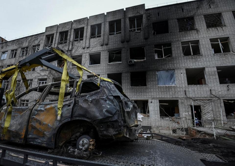 PHOTO: Communal workers prepare a damaged car to be towed near a residential building damaged during a Russian drone strike, amid Russia's attack on Ukraine, in Dnipro, Ukraine, Jan. 7, 2024.  (Mykola Synelnykov/Reuters)