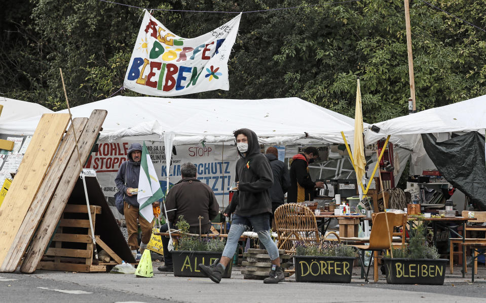 A camp of climate activists with signs reading 'all villages stay' is pictured at the edge of the Garzweiler surface coal mine near Keyenberg, Germany, Friday, Sept. 25, 2020. Several groups like 'Friday for Future' or 'Ende Gelaende' started actions for climate justice in the coming days throughout Germany. The movement demands that the German government phase out coal by 2030 and make Germany carbon neutral by 2035. (AP Photo/Martin Meissner)