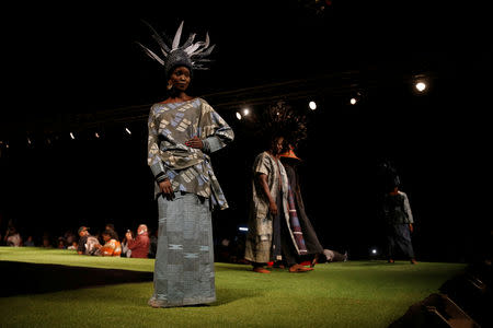 A model walks on a catwalk during a fashion show featuring African fashion and culture as part of a gala marking the launch of a book called "African Twilight: The Vanishing Rituals and Ceremonies of the African Continent" at the African Heritage House in Nairobi, Kenya March 3, 2019. REUTERS/Baz Ratner