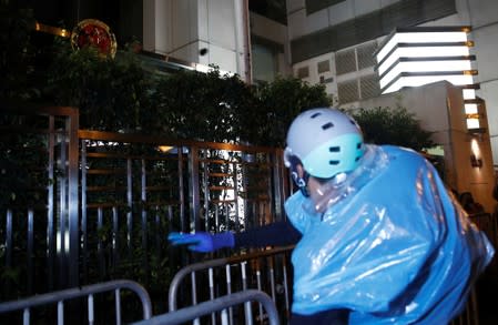 A protester vandalises Chinese Liaison Office after a march to call for democratic reforms, in Hong Kong