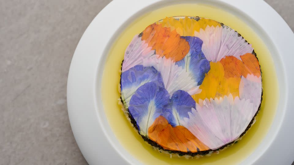 Mauro Colagreco's starter, named Tourteau & Oscietra Caviar, is blanketed with flower petals grown on his restaurant's farm. - Lai Sun Dining