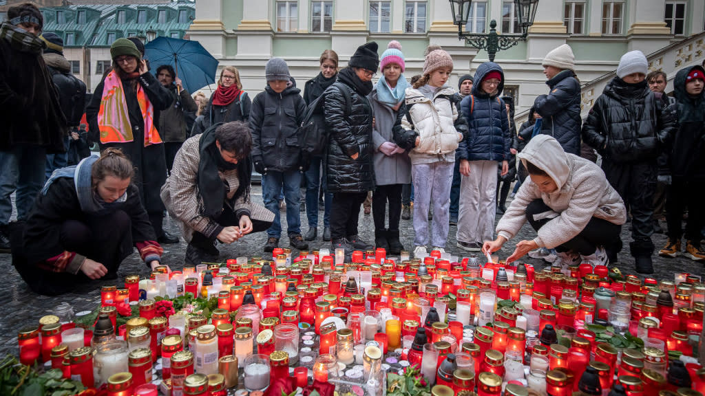  Mourners light candles in Prague for those killed in deadly mass shooting. 