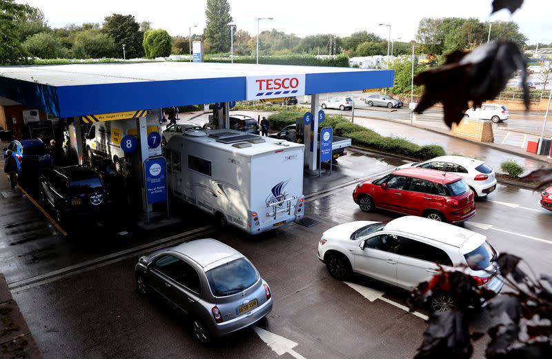 Vehicles queue for fuel at a Tesco petrol station in Stoke-on-Trent