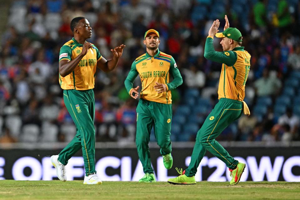 South Africa's Kagiso Rabada (L) celebrates after the dismissal of Afghanistan's Ibrahim Zadran during the ICC men's T20 World Cup 2024 semi-final cricket match between South Africa and Afghanistan at Brian Lara Cricket Academy in Tarouba, Trinidad and Tobago, on June 26, 2024.