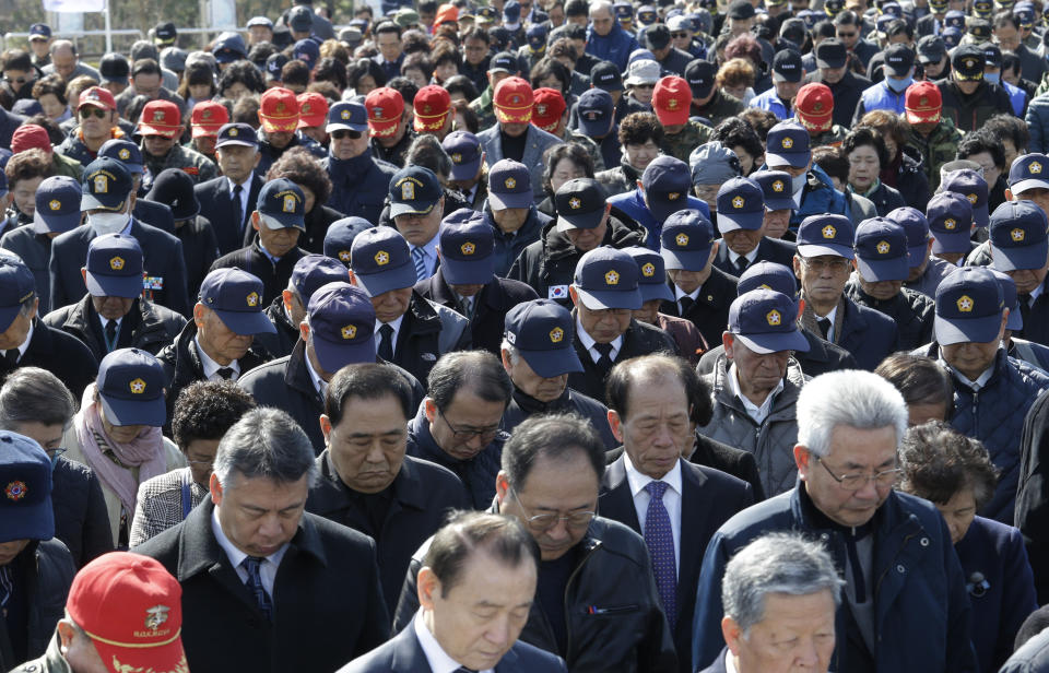 Participants pay a silent tribute during a ceremony to commemorate South Korean soldiers killed in three major clashes with North Korea in the West Sea, in Seoul, South Korea, Friday, March 22, 2019. The South Korean government has designated the fourth Friday of March as the commemoration day for the fallen soldiers in the clashes, including the North's torpedoing of the South Korean Navy corvette Cheonan in 2010, which killed 46 sailors. (AP Photo/Ahn Young-joon)