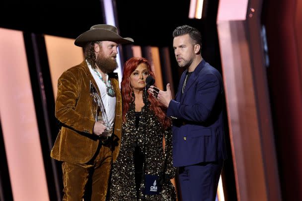 PHOTO: John Osborne, Wynonna Judd and T.J. Osborne speak onstage at The 56th Annual CMA Awards at Bridgestone Arena on Nov. 9, 2022, in Nashville, Tenn. (Terry Wyatt/WireImage via Getty Images)