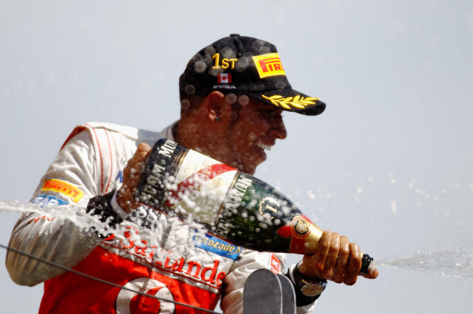 MONTREAL, CANADA - JUNE 10: Lewis Hamilton of Great Britain and McLaren celebrates on the podium after winning the Canadian Formula One Grand Prix at the Circuit Gilles Villeneuve on June 10, 2012 in Montreal, Canada. (Photo by Paul Gilham/Getty Images)